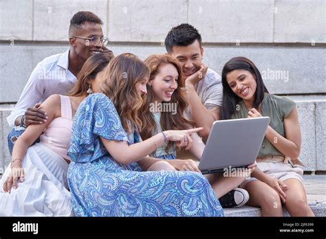 Group Of Multi Ethnic People Using Laptop Together While Sitting On