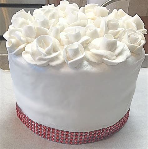 White wedding cake with dahlias,. Wedding cake layer. White buttercream frosting with Royal ...