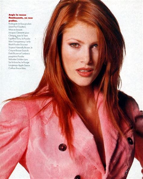 A Woman With Red Hair Wearing A Pink Jacket