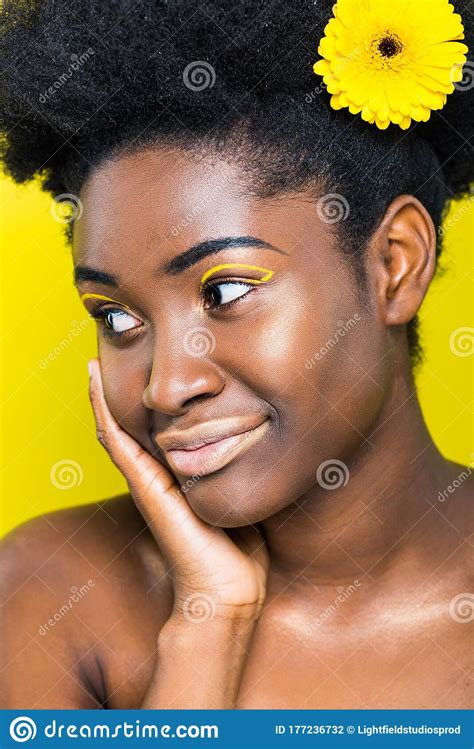 Dreamy African American Woman With Flower In Hair Looking Away Stock Photo Image Of Makeup