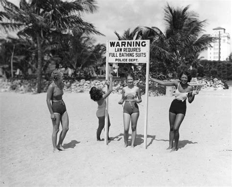Florida Memory • Young Women Making Fun Of Sign At Beach Requiring Full