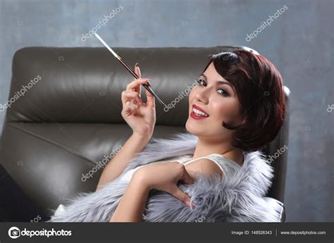 Woman Smoking With Cigarette Holder — Stock Photo © Belchonock 148526343