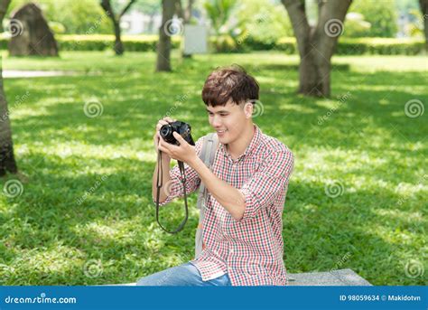 Young Smiling Man Taking Picture In The Park Stock Photo Image Of