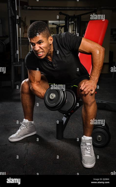 Young Man Doing Biceps Curl Workout In Gym Stock Photo Alamy