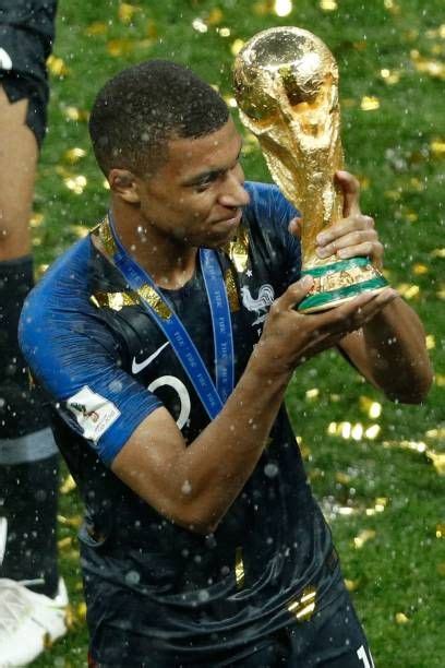 france s forward kylian mbappe holds the trophy as he celebrates during the trophy ceremony