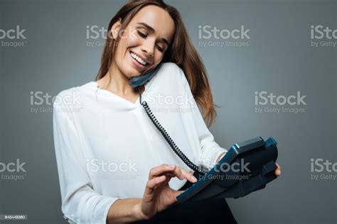 Delighted Positive Woman Dialing A Number Stock Photo Download Image