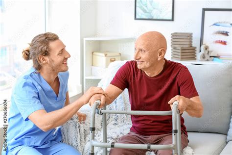 Elderly Man With Caregiver In Nursing Home Stock Photo Adobe Stock