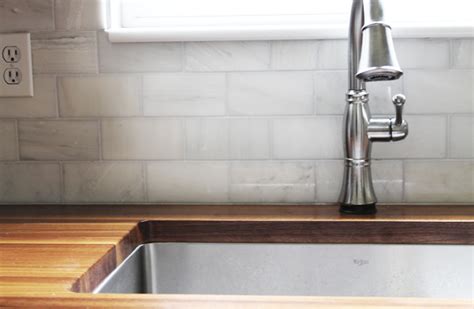 Apparently, he didn't seal the marble tiles before grouting. That Hampton Carrara Marble Backsplash-Done-zo!! - Chris Loves Julia