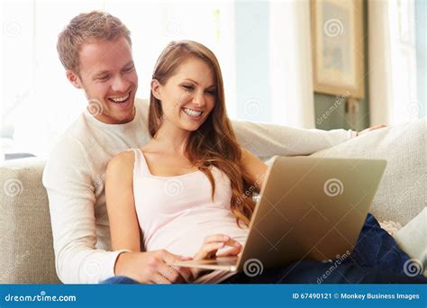 Couple Relaxing On Sofa Using Laptop Computer Together Stock Image Image Of Internet Female