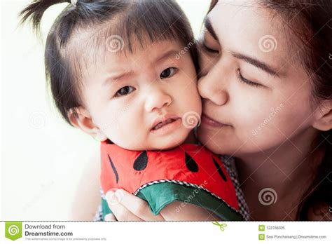 Sad Asian Baby Girl Crying And Mother Comforting Her Royalty Free Stock