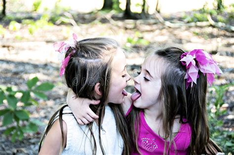 See My Tongue Two Sisters Playfully Showing Each Other Their Tongues