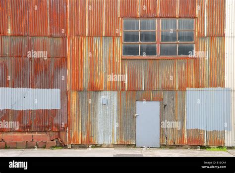 Rusted Corrugated Metal Wall Of A Warehouse Building In A Industrial