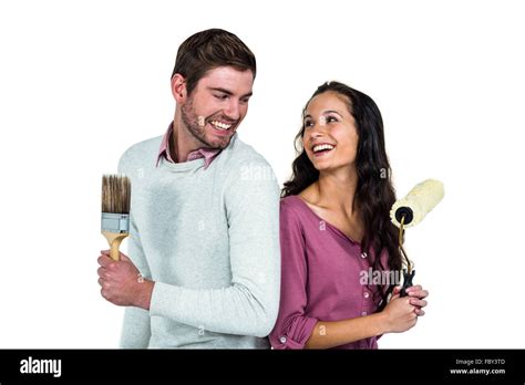 Smiling Couple Holding Brushes Stock Photo Alamy