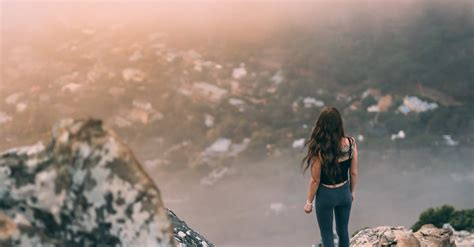 Woman Standing On The Edge Of A Cliff · Free Stock Photo