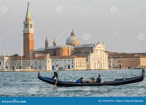 Tourists On A Gondola Venice San Giorgio Maggiore Island Venice