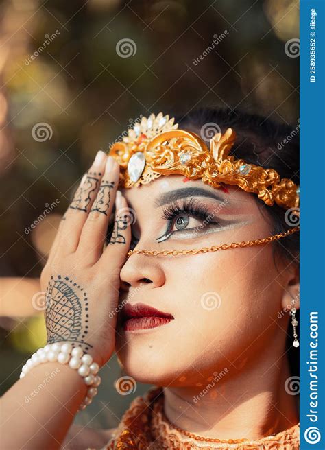 Asian Woman Covering Her Face With Hands Full Of Tattoos While Wearing