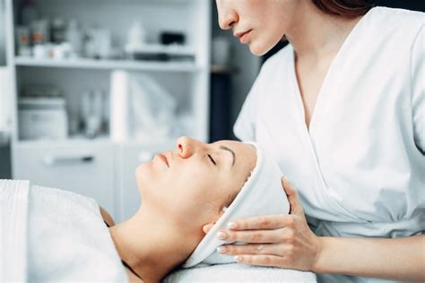 Premium Photo Beautician Makes Face Massage To Female Patient