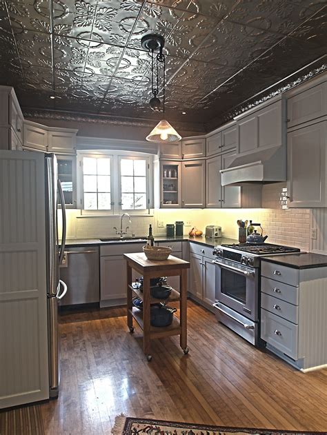 Tin ceiling tiles are a simple way to make a big impact and affordable way to transform any home our entire kitchen was designed around two panels accented with tin ceiling tiles that would be. Idea for ceiling for Laundry room and Hallway by stairs ...
