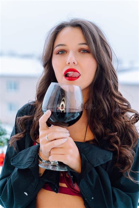 Portrait Of Young Woman Wearing Unbuttoned Black Shirt Red Bra Holding Glass With Red Wine