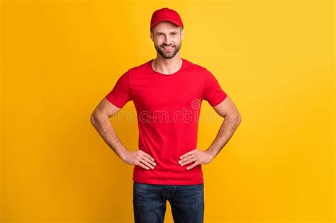 photo of positive bristled guy hands hips toothy white smile wear red t shirt hat isolated