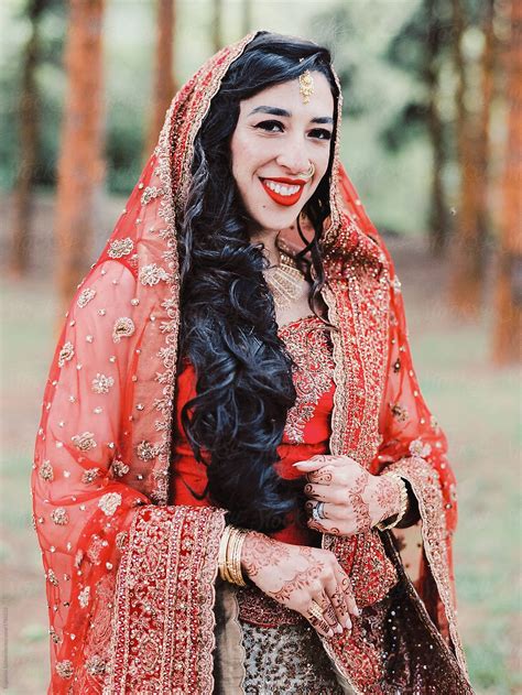 Portrait Of An Indian Bride Wearing Traditional Wedding Sari By Stocksy Contributor Evgeniya