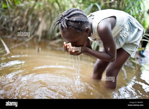 African Child Drinking Dirty Water Hi Res Stock Photography And Images