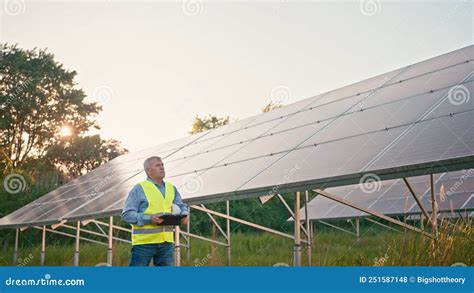 Inspector Engineer Man Holding Digital Tablet Working In Solar Panels