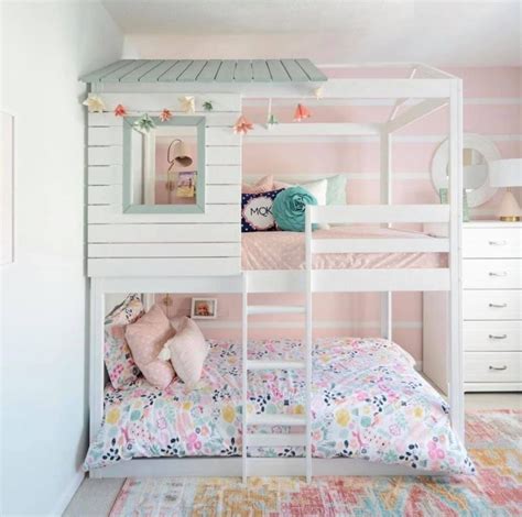 A White Bunk Bed Sitting In A Bedroom Next To A Pink Wall