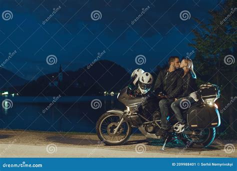 Happy Romantic Biker Couple In Love Kissingmotorcycle With Bags