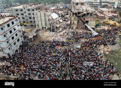 File In This April 25 2013 File Photo Bangladeshi People Gather As Rescuers Search For