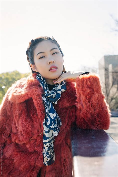 Sunny Outdoor Portrait Of Young Pretty Asian Girl In Red Fur Coat Del