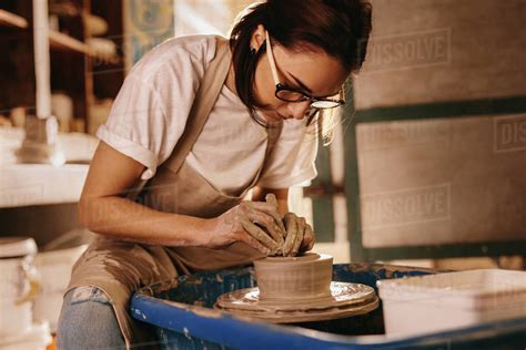 Woman Moulding Clay On Pottery Wheel Craftswoman Making Pot In