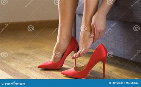 Beautiful Business Woman Takes Off Red High Heels And Massages Painful Legs Stock Video Video