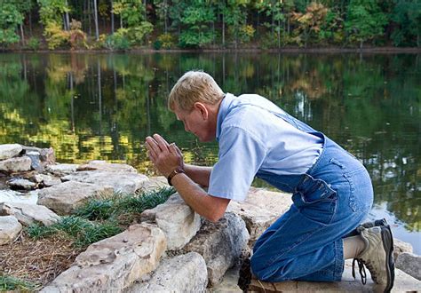 Man Praying On Knees Pictures Images And Stock Photos Istock
