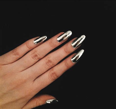 A Womans Hand With Silver Nail Polish On Her Nails And Gold Manicures