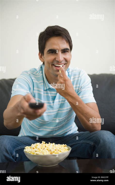 Indian Man Eating Popcorn Watching Hi Res Stock Photography And Images