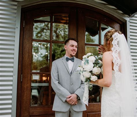 a bride and groom are standing in front of the door to their wedding ceremony venue