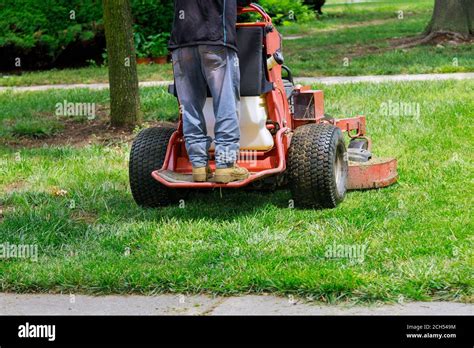 Man Worker Cutting Grass In Summer With A Professional Gardener Mowing Lawn Stock Photo Alamy
