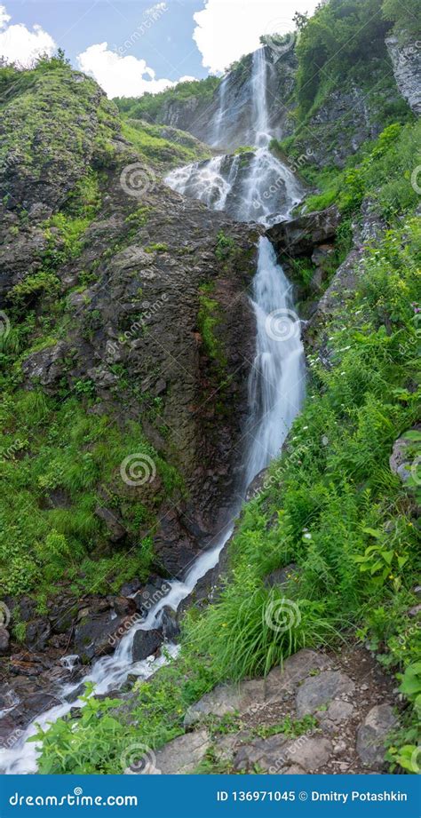 High Waterfall With A Powerful Stream Falling From A Cliff Stock Image