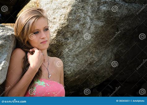 Pretty Blue Eyed Brunette Girl In Bikini Against Rocks Stock Image