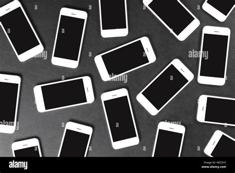 White Smartphones Lying On Dark Surface Stock Photo Alamy