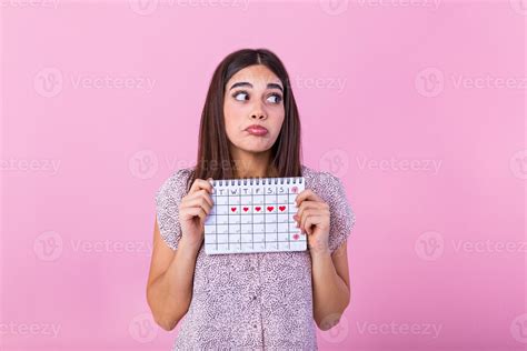 Portrait Of Young Woman In Dress Holding Female Periods Calendar For