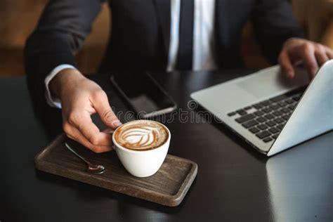 Handsome Young Businessman Sitting In Cafe Using Laptop Computer