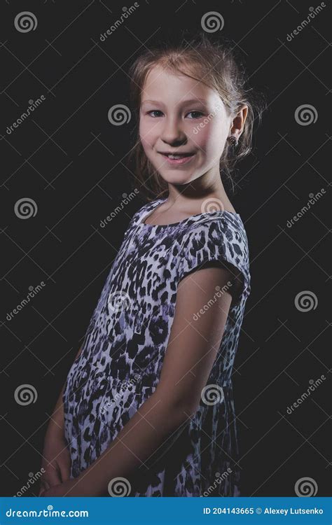 Portrait Of A Cute Little Girl On A Black Background Low Key Studio