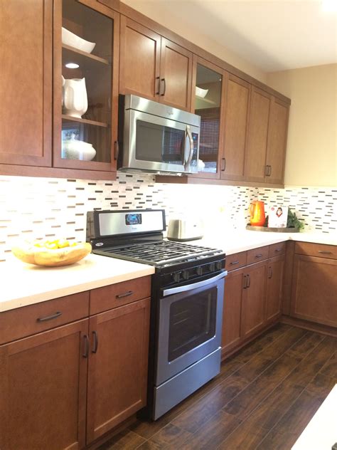 Here's advice on opaque finishes for cabinets. Medium Brown Kitchen Cabinets w/ Light Quartz Countertop ...