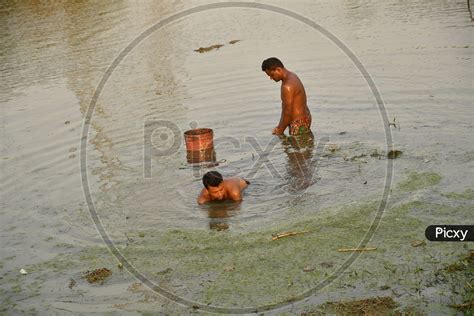 Image Of Indian Men Taking Bath In The Pond Water Gj Picxy