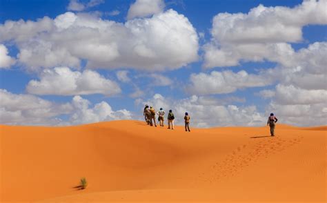 Premium Photo People Walk Of The Sahara Desert