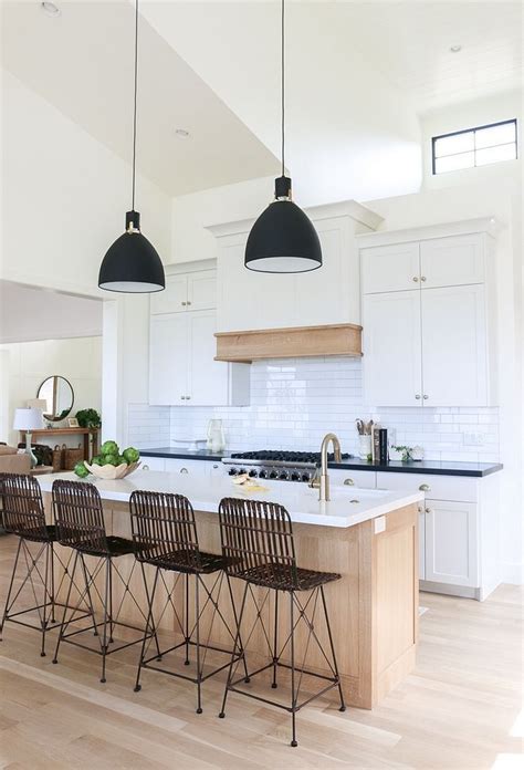 White Kitchen With Light Oak Island And Light Wood Floors The Black