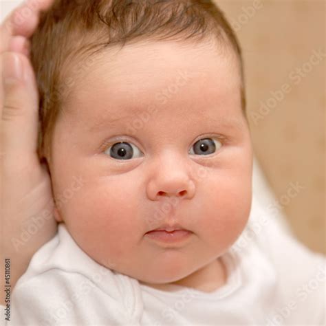 Portrait Of A Newborn Baby Close Up Child Has Beautiful Eyes Stock