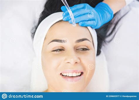Beautiful Woman Receiving Face Cleaning Procedure In Salon Skincare